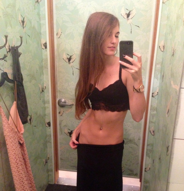 Sexy slim beauty takes a bathroom selfie, in her black lingerie.