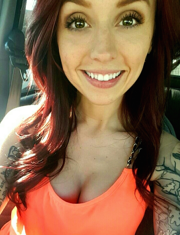 Selfie in the car of a hot woman with red honey highlighted hair