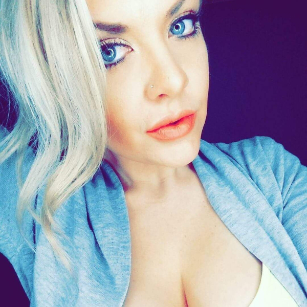Hot blonde with pretty deep blue eyes clicking a sexy cleveage selfie