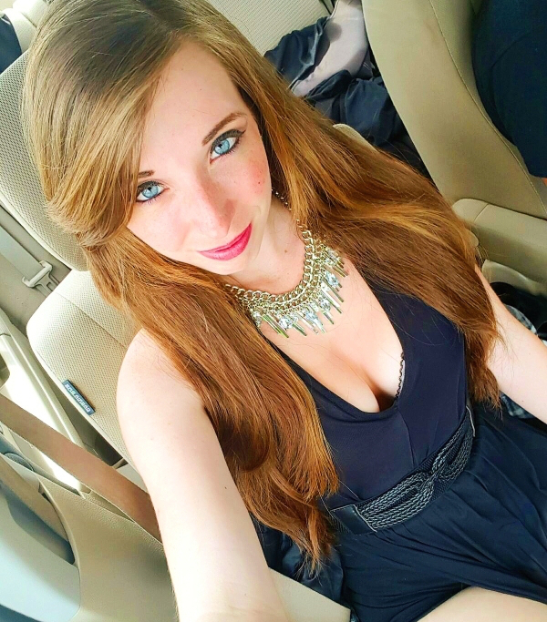 Blue eyed beauty in pretty dress in the car