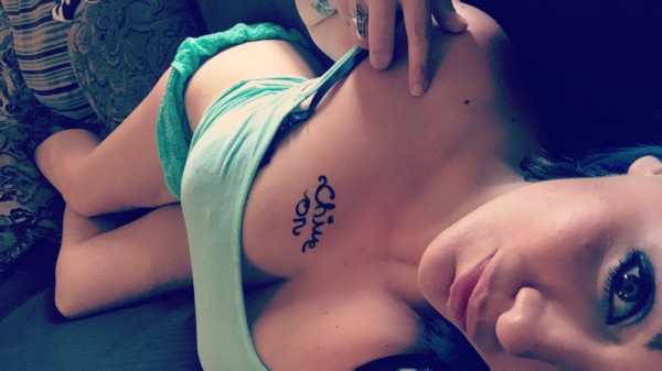 Sexy Chivette pulls down her green bra to reveal her big cleavage with the words 'Chive On' on it.