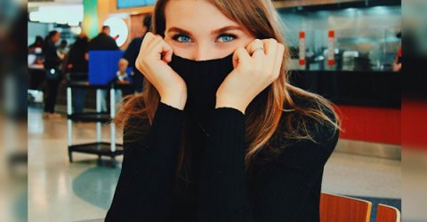 Sexy model Elizabeth Zaks covers her face with her black dress, and reveals her beautiful, blue eyes.