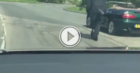 An old Man scooters down a busy road (Video)