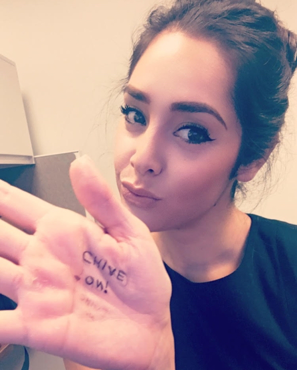Sexy girl in black pouts with 'Chive On' text in her palm.