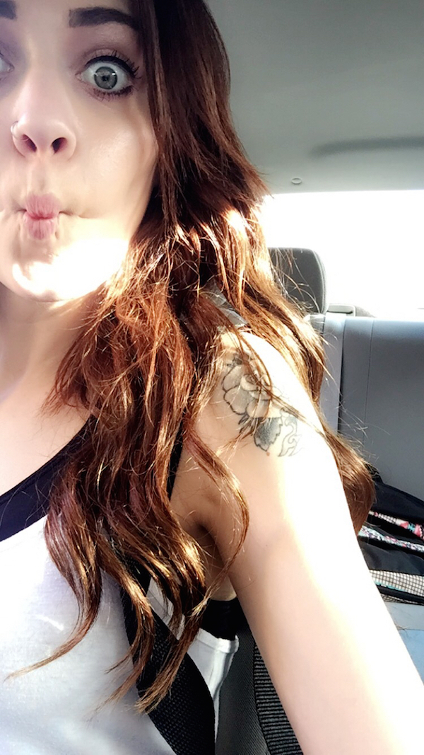 Naughty girl posing for a extreme duck face selfie wide wide open eyes in car