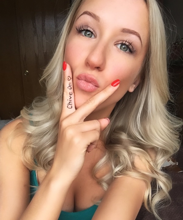 Sexy girl posing a pout with "Chive on" written on her fingers
