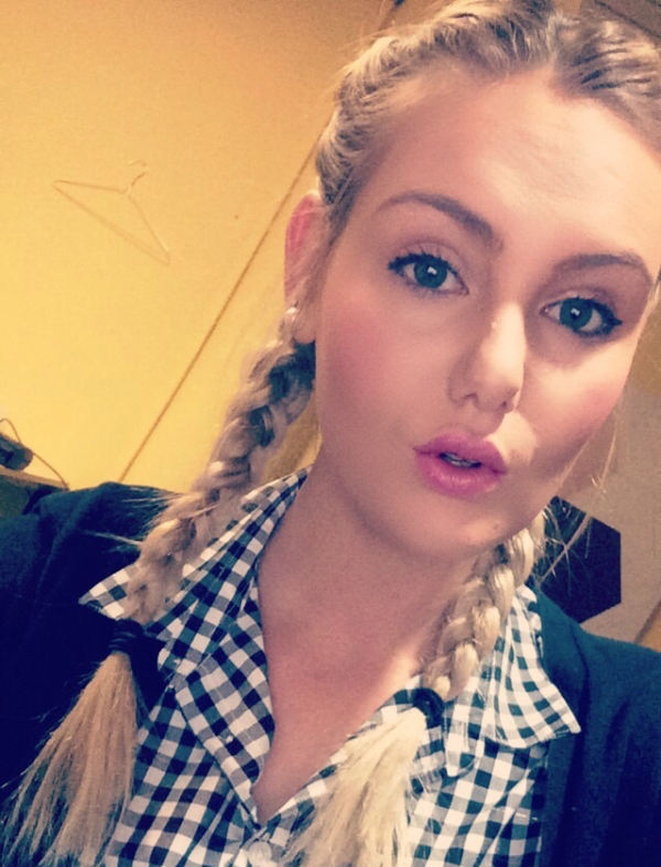 Girl with two braids makes a sexy pink pout