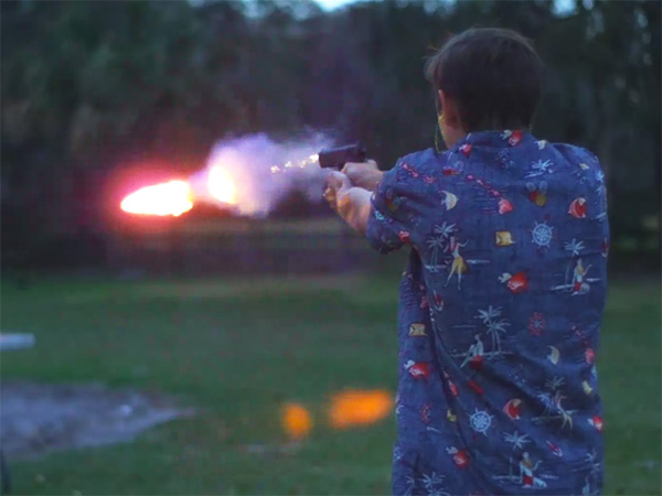 Man shooting out a fire bullet from a gun