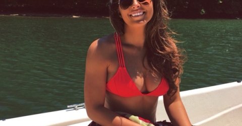 Pretty woman wearing three strap red bikini top, cool goggles, has sexy saggy boobs