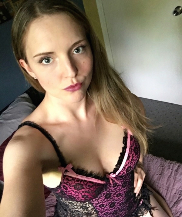 Girl making a pout and wearing a sexy pink and black lingerie