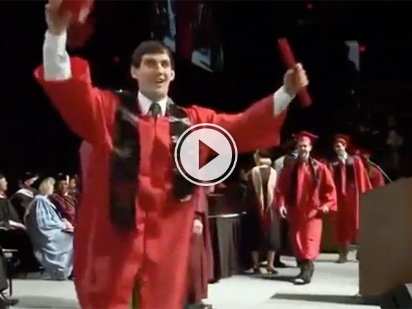 Dude in red graduation gown exults after getting the degree!