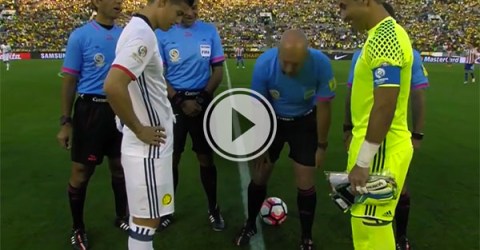 Referee in blue tee and black shorts places the ball to begin a soccer game!