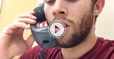 Dude in burgundy tee talking on a landline!