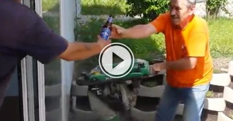 Man in orange tee and blue jeans accepts a bottle of beer from another man!