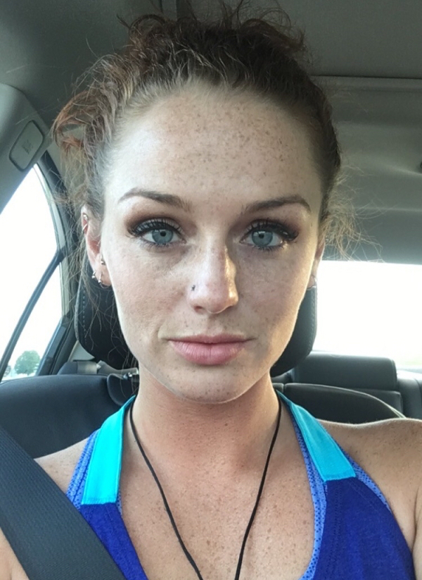 Freckled girl with blue eyes clicks a selfie