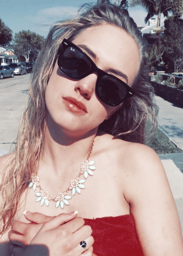 Girl outdoors wearing a RayBan sunglasses wearing a red dress