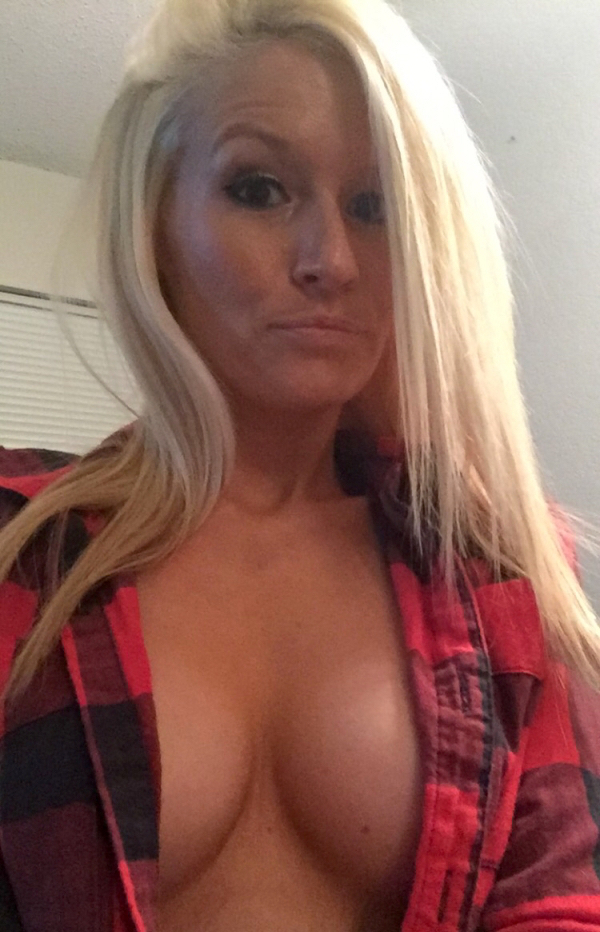 Blonde lady in an unbuttoned red chequered shirt just covering her nipples