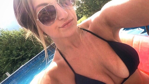 Girl in Aviators wearing a back bra clicks a selfie by the poolside