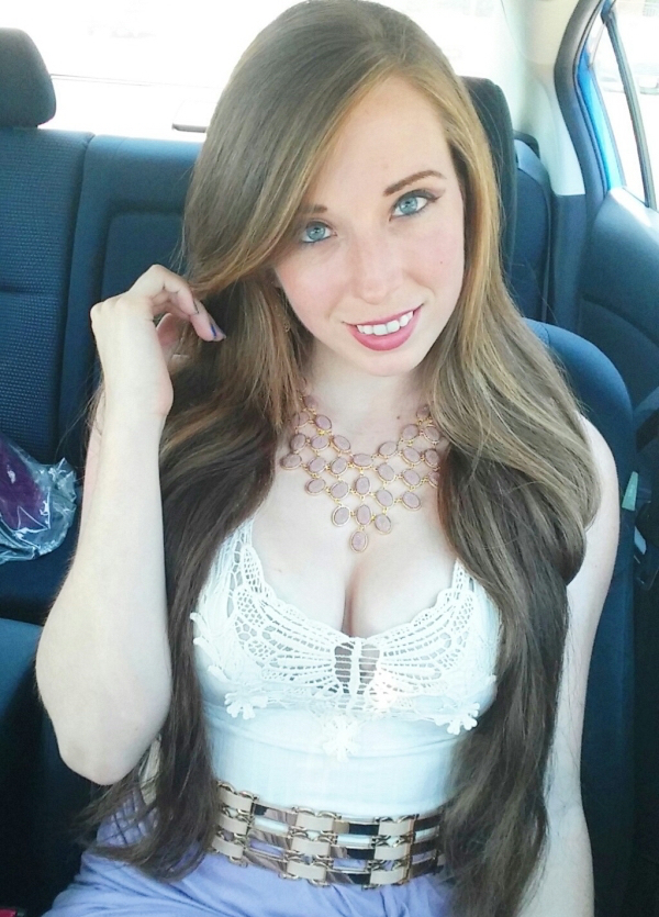 Busty blue eyed girl in a picture in a car