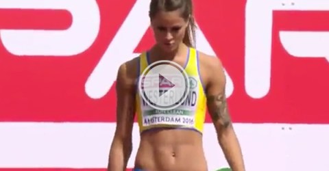 screenshot of a Live video of sexy tattooed athlete in yellow sports bra and blur hipster while running