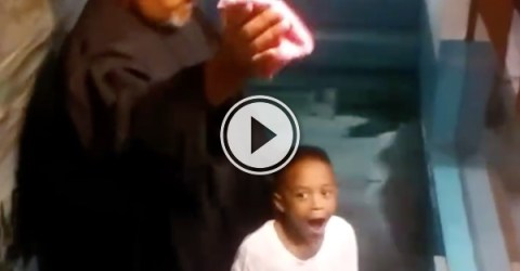 Overly excited boy baptizes himself (Video)