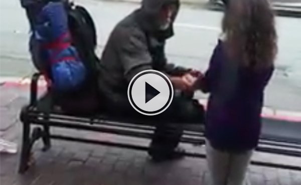 Little girl gives food to homeless man