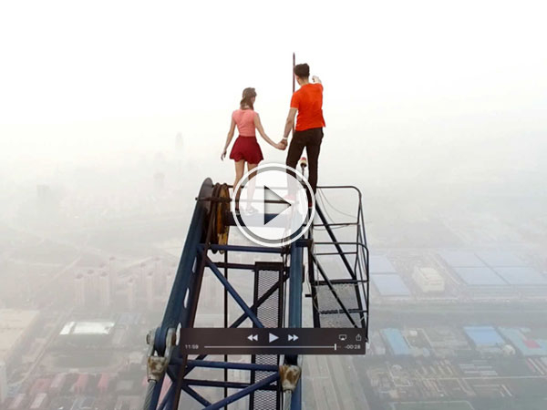 Daredevil couple climb china's tallest crane on a date (Video)
