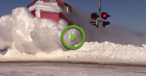 Train obliterates massive snowbank (Video)