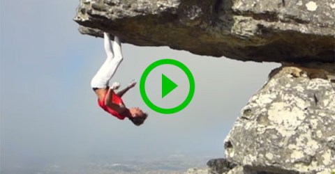 Rock climber hangs upside down from rock face (Video)
