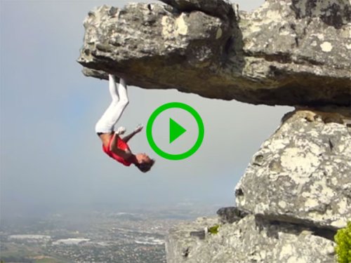 Rock climber hangs upside down from rock face (Video)