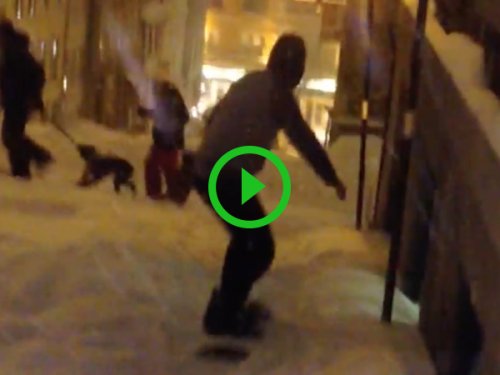 Guy snowboarding down street gets hit by car (Video)