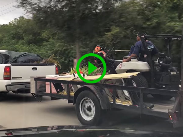 Dude rides on mower hitched to back of truck (Video)