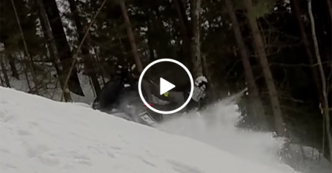 Man gets hit by own snowmobile on climb (Video)