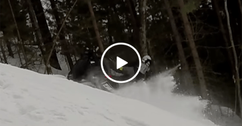 Man gets hit by own snowmobile on climb (Video)