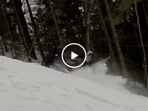 Man gets hit by own snowmobile on climb (Video)