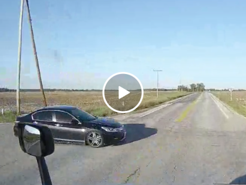 Car almost gets t-boned by truck (Video)
