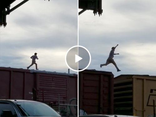 Guy runs on top of train