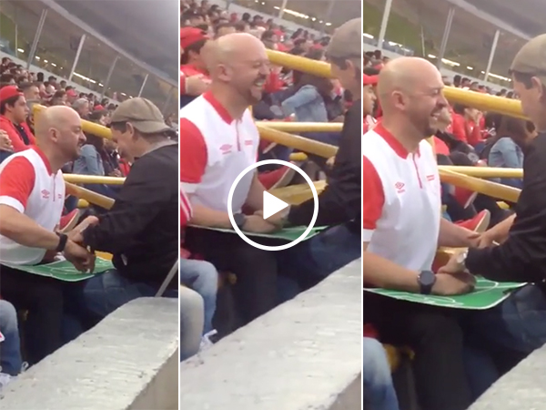 Father helps blind son watch soccer game with mini-pitch