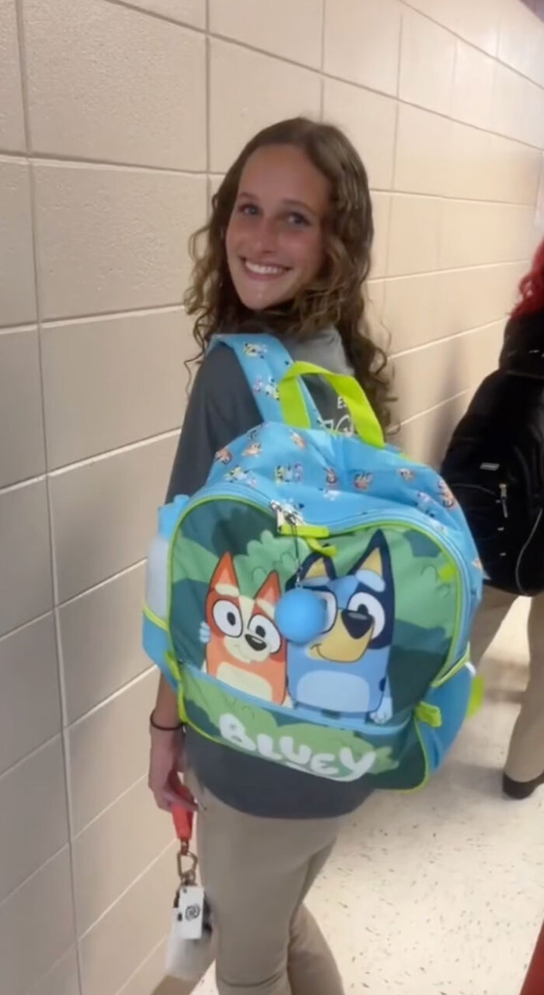 Graduating Seniors Carry Childish Kindergarten Backpacks